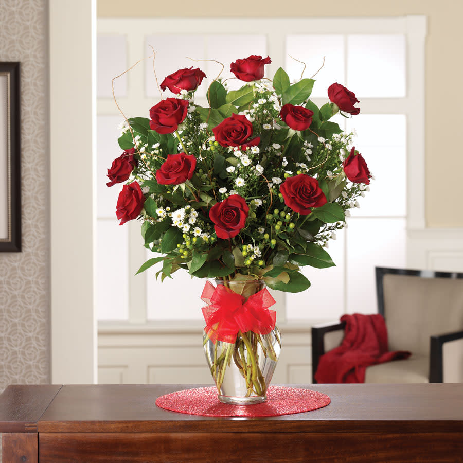 Rose Elegance Premium Long Stem Red Roses - Looking for a gift that says &quot;I love you&quot; like no other? Look no further than our Rose Elegance Premium Long Stem Red Roses! These beautiful, premium quality blooms are the perfect way to express your love and admiration for that special someone in your life.  Here are just a few of the amazing features and benefits of our long stem red roses:  - Premium quality: Our roses are carefully selected for their beauty, freshness, and long-lasting appeal. Each stem is hand-picked by our expert florists to ensure that only the best make it into our arrangements. - Long stems: With 15 long stem roses in each arrangement, you can be sure that your gift will make a bold and beautiful statement. The long stems add an elegant touch to this already stunning bouquet. - Classic red roses: Red roses are the classic symbol of love and romance, making them the perfect choice for any occasion. Whether you're celebrating an anniversary, Valentine's Day, or just want to show someone special how much you care, these roses are sure to impress. - Convenient delivery: With our flower delivery service, you can send these gorgeous roses right to your loved one's door. We'll make sure your gift arrives on time and in perfect condition.  So why wait? Order your Rose Elegance Premium Long Stem Red Roses today and show that special someone just how much they mean to you. With their stunning beauty, premium quality, and convenient delivery, these roses are the perfect way to say &quot;I love you&quot; in style.