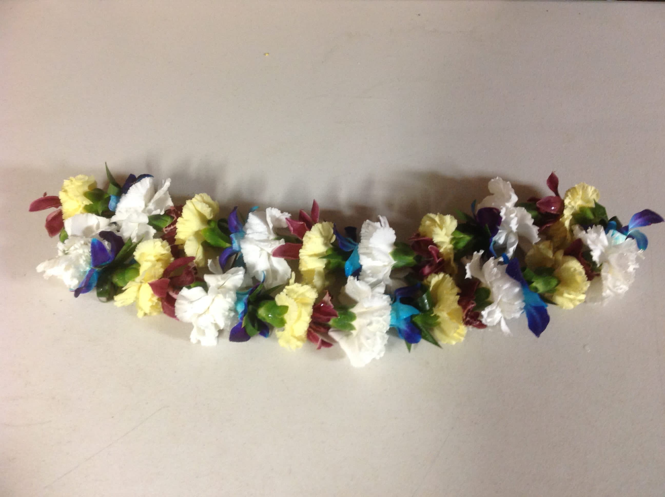 Leis #10 Leis #10 - Our beautiful leis are great for graduations, birthdays, or any celebration! WARNING: DYED ORCHIDS, MIGHT STAIN CLOTHES.