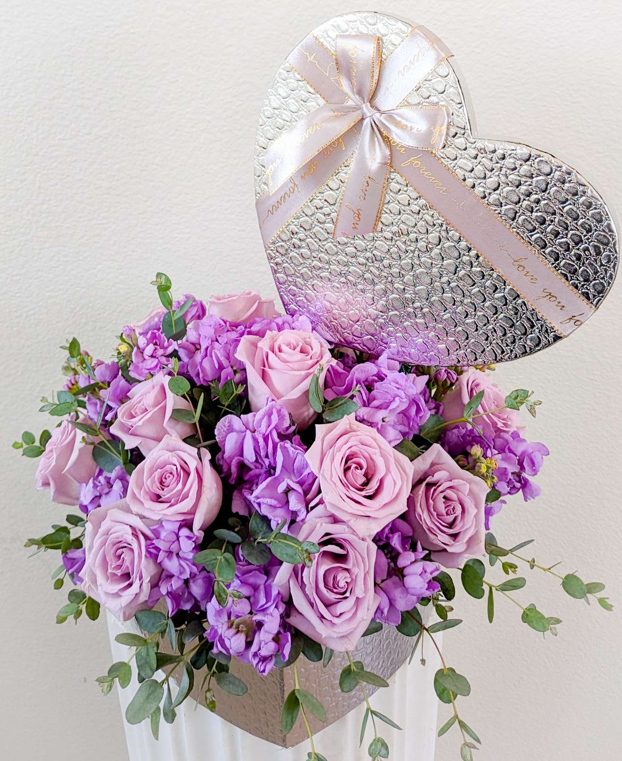 Lavender Rose Small Heart Box - Small(8&quot; width) heart box filled with lavender roses, lavender stock, and eucalyptus greenery.