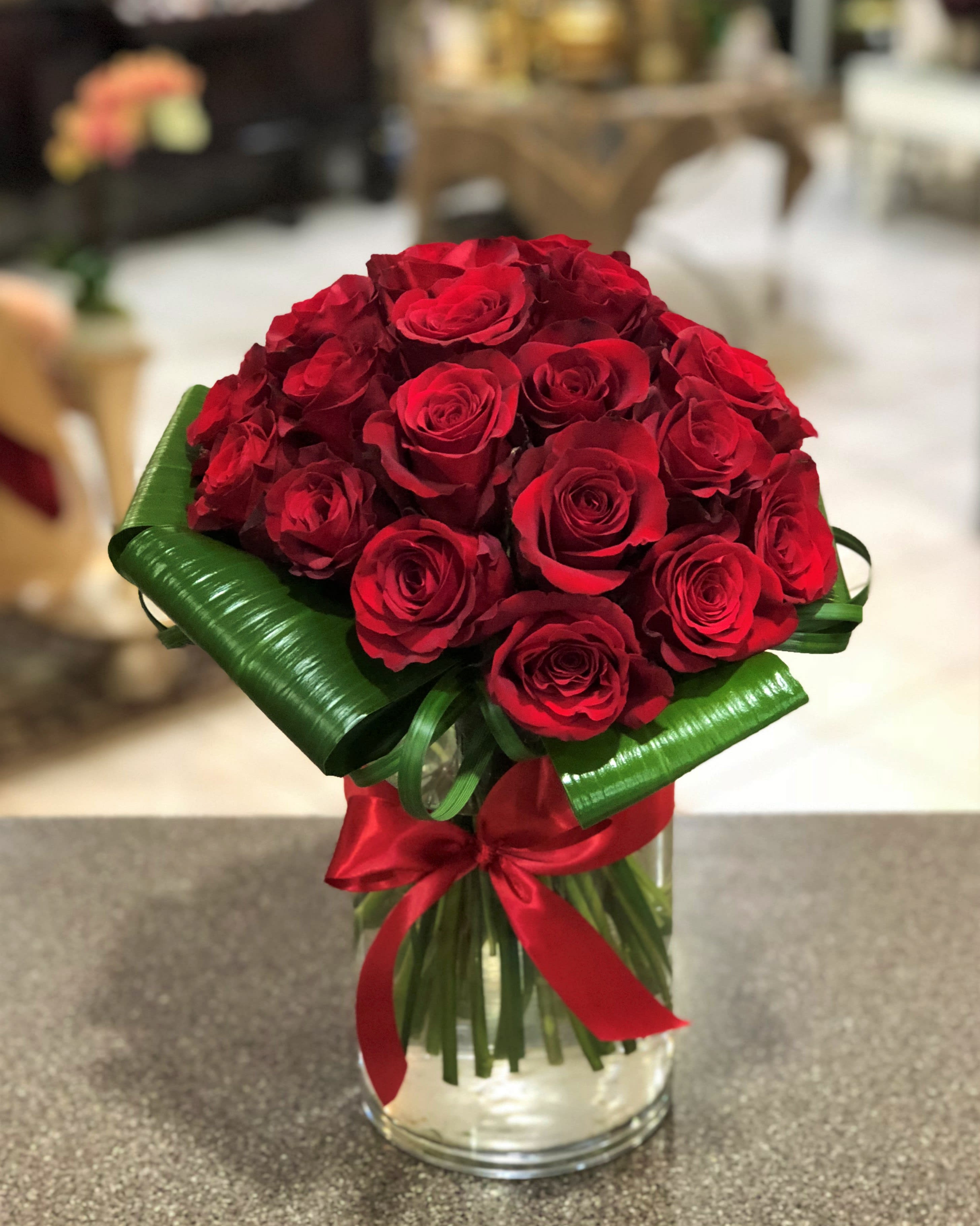 Passion - Take her breath away with 18 of our premium red roses in a cluster style arrangement.  Also available in other colors based on availability.