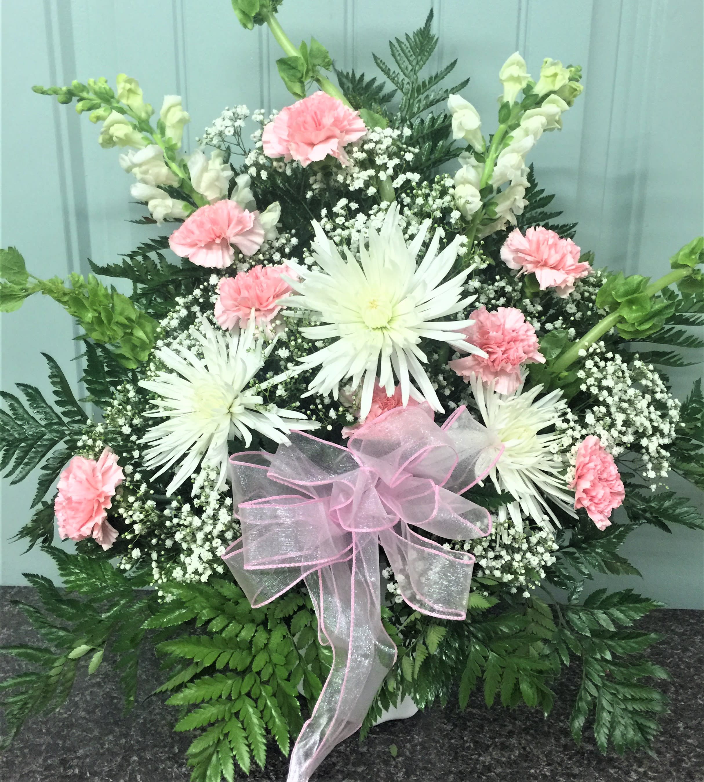sincere in pink - sympathy basket in white and pink with carnations spider mum and snaps. as with all my arrangements you can change colors to meet your needs