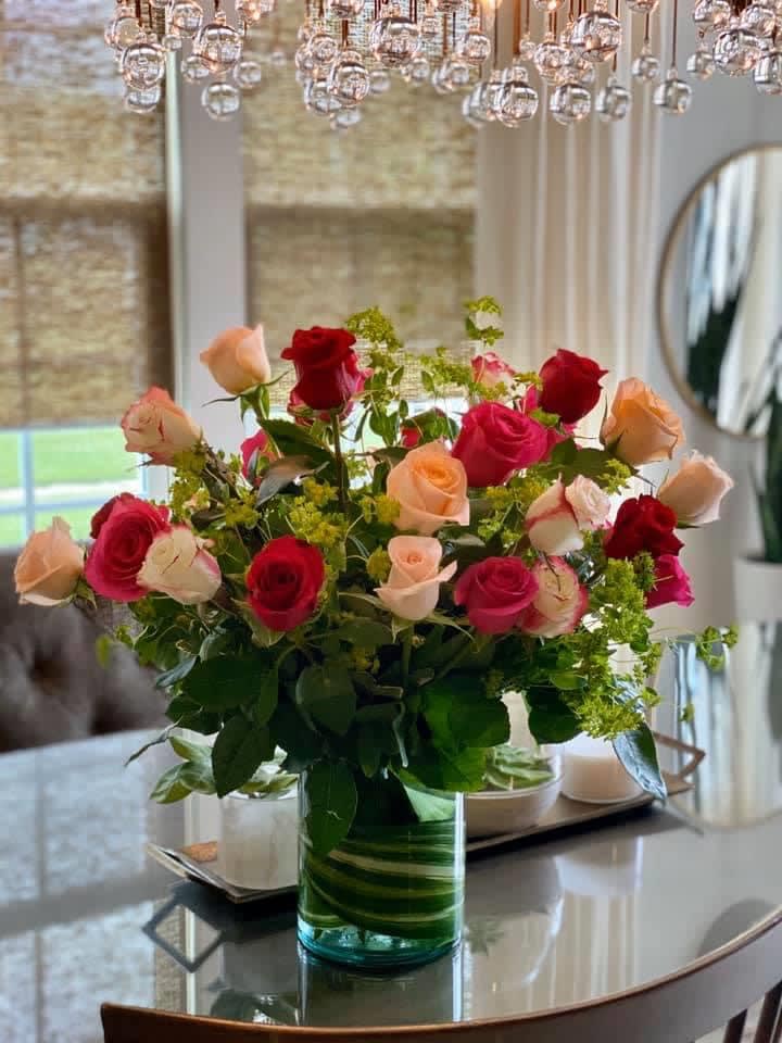2 Dozen Mixed Roses - Mixed colors of roses arranged with bupleurum in a leaf lined hurricane cylinder is a stunning way to celebrate a special day. 