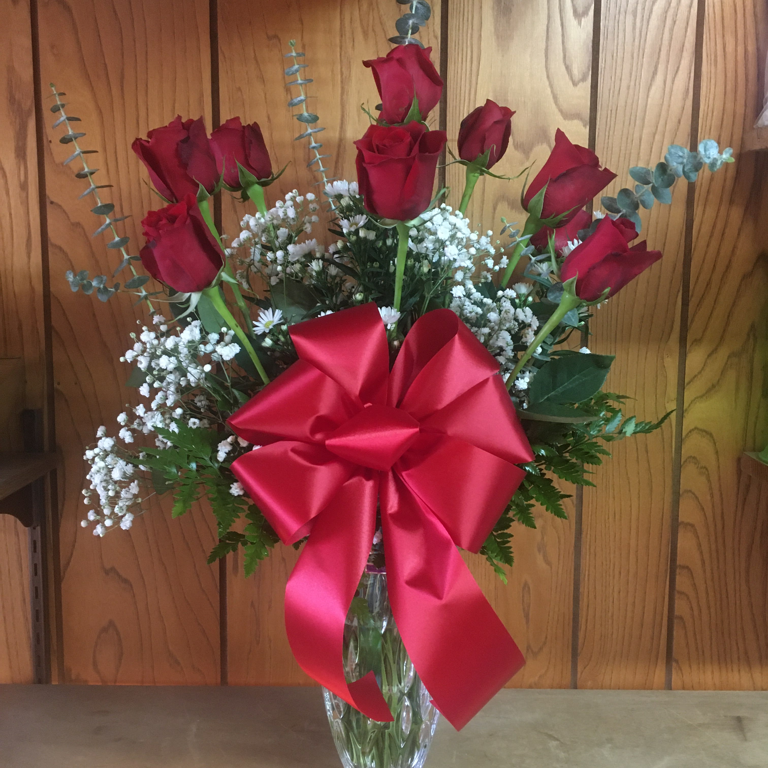 Crystal Rainfall w/ Red Roses - Send this elegant gift of red roses arranged in authentic 9&quot;H Waterford Crystal vase styled and etched in a Rainfall design. Includes greens, filler, eucalyptus, and ribbon. 12 roses for standard; 18 roses for deluxe.
