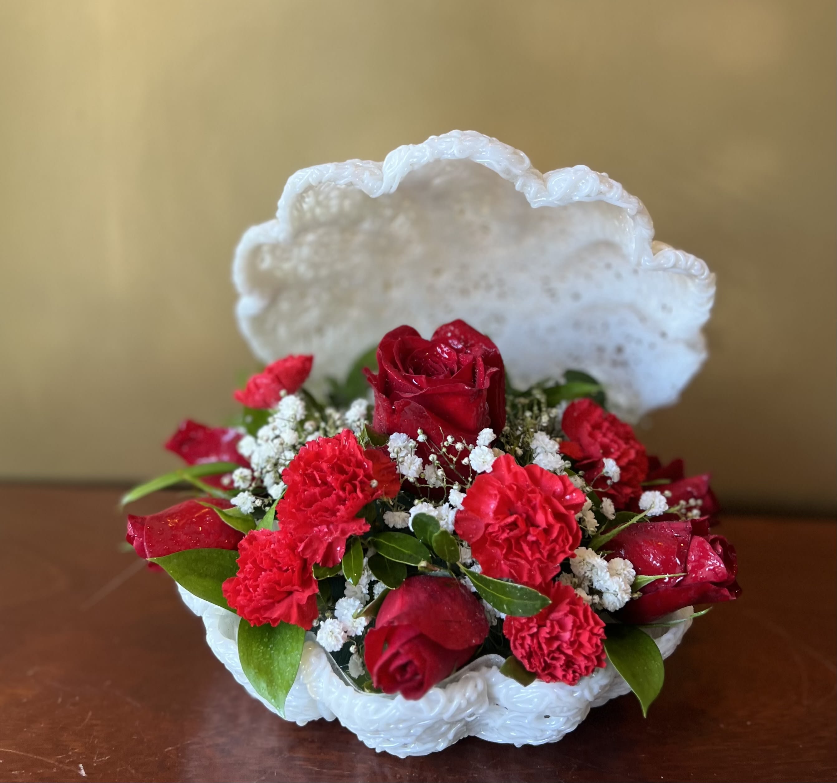 Love in a Seashell  - Proclaim your eternal love with this beautifully designed arrangement of roses and carnations in a seashell inspired vase. 
