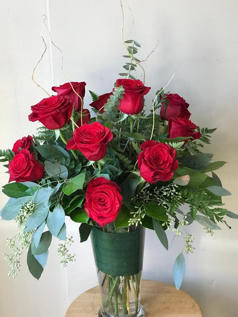 Dozen Red Roses in Vase - Beautiful roses in a vase with some eucalyptus to give it that extra touch. If you would prefer another colored rose please write what color you would like in the special instructions. Thank you.