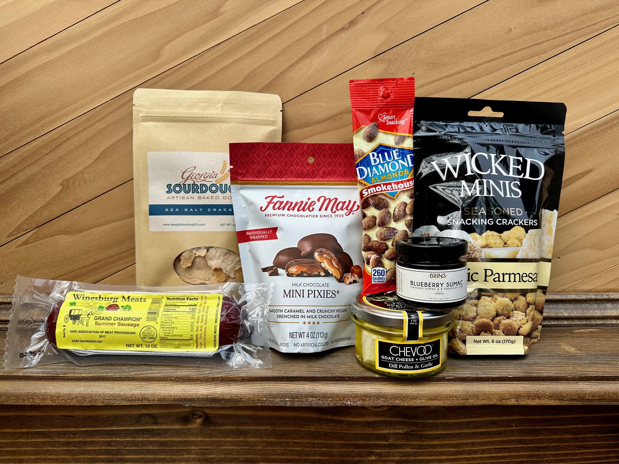 Gourmet Basket- Standard - Our baskets are filled with a variety of unique items. We include an array of snacks, such as Fannie May chocolates, jam, nuts, sausage, cheese, crackers, candy and more. Give us a call with any questions or specifications.  
