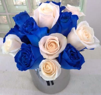 Maccabee - We've taken blue and white roses and arranged them in a contemporary style, low, tight and compact, in a low cylinder.   Perfect for a baby boy, bar mitzvah, Hanukkah, יום העצמאות or any other occasion you can think of when blue and white are the colors of the day!