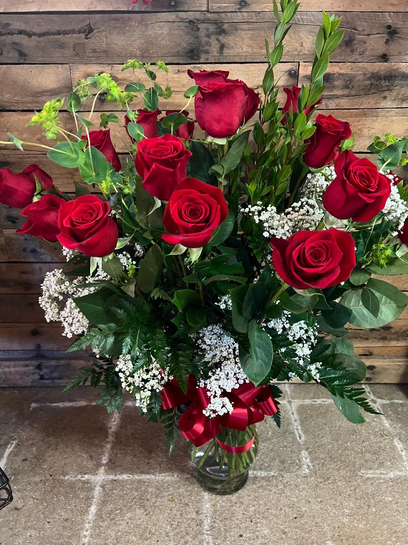 Two Dozen Red Roses - An impressive presentation of two dozen fragrant, long-stemmed red roses accented with greenery is a classic gift for Valentines Day, a romantic birthday, an anniversary or as a memorial tribute. Its a traditional gift that symbolizes love. Available in many colors