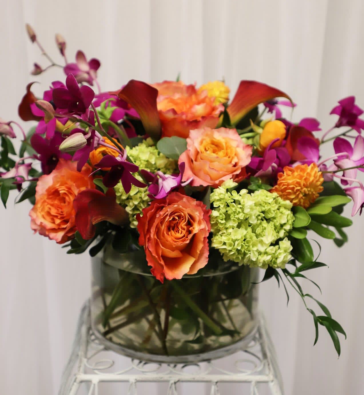 Dior  - This colorful design features brilliant orange and pops of purple blooms.  This gift is sure to breathe new life into any home.