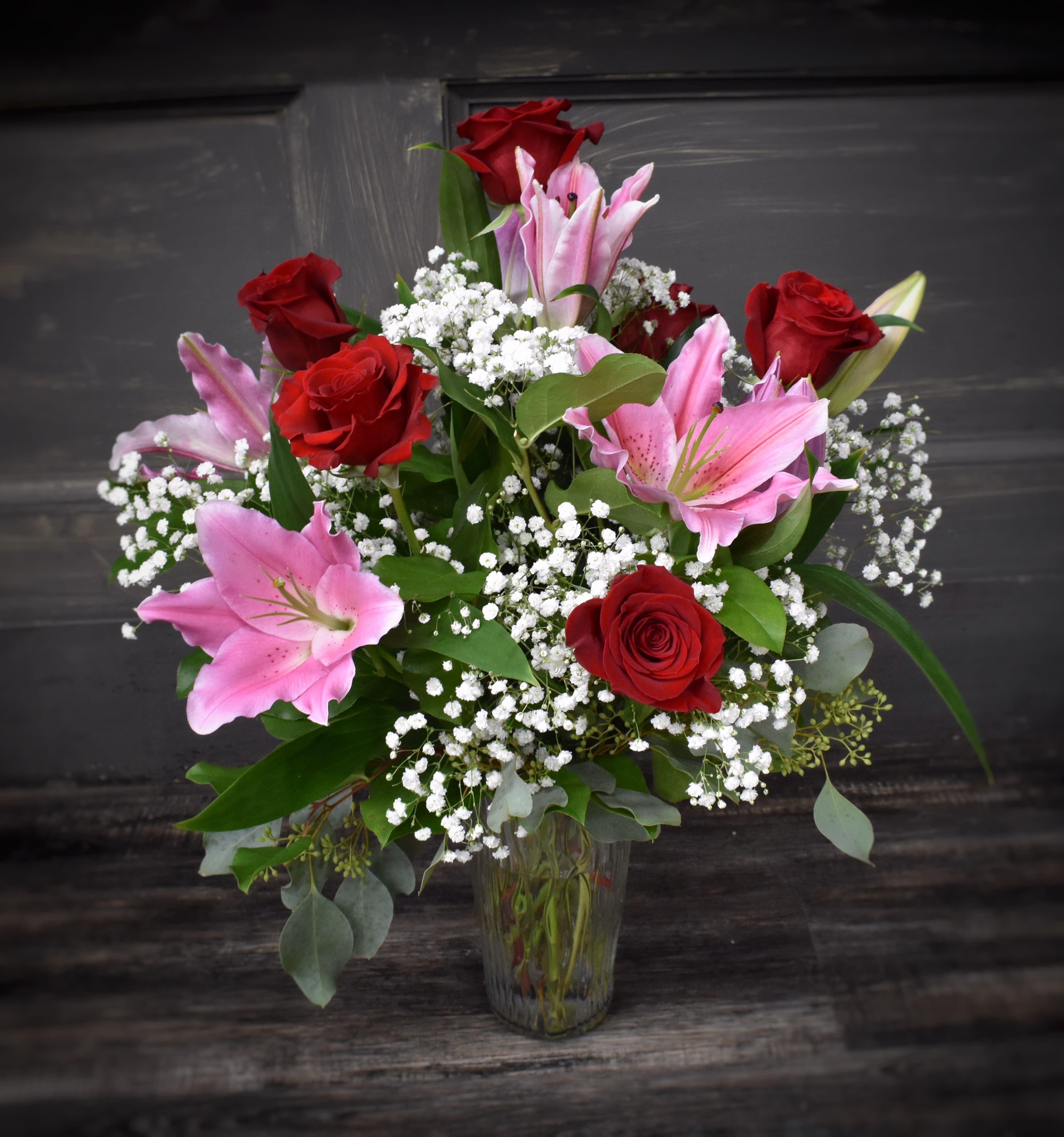 Roses and Lilies - Available for local St Cloud area delivery - One of our most popular designs, this bouquet is designed in a glass vase with 6 long stemmed roses, 3 stems of oriental lilies, assorted green foliages and babies breath as an accent flower. 