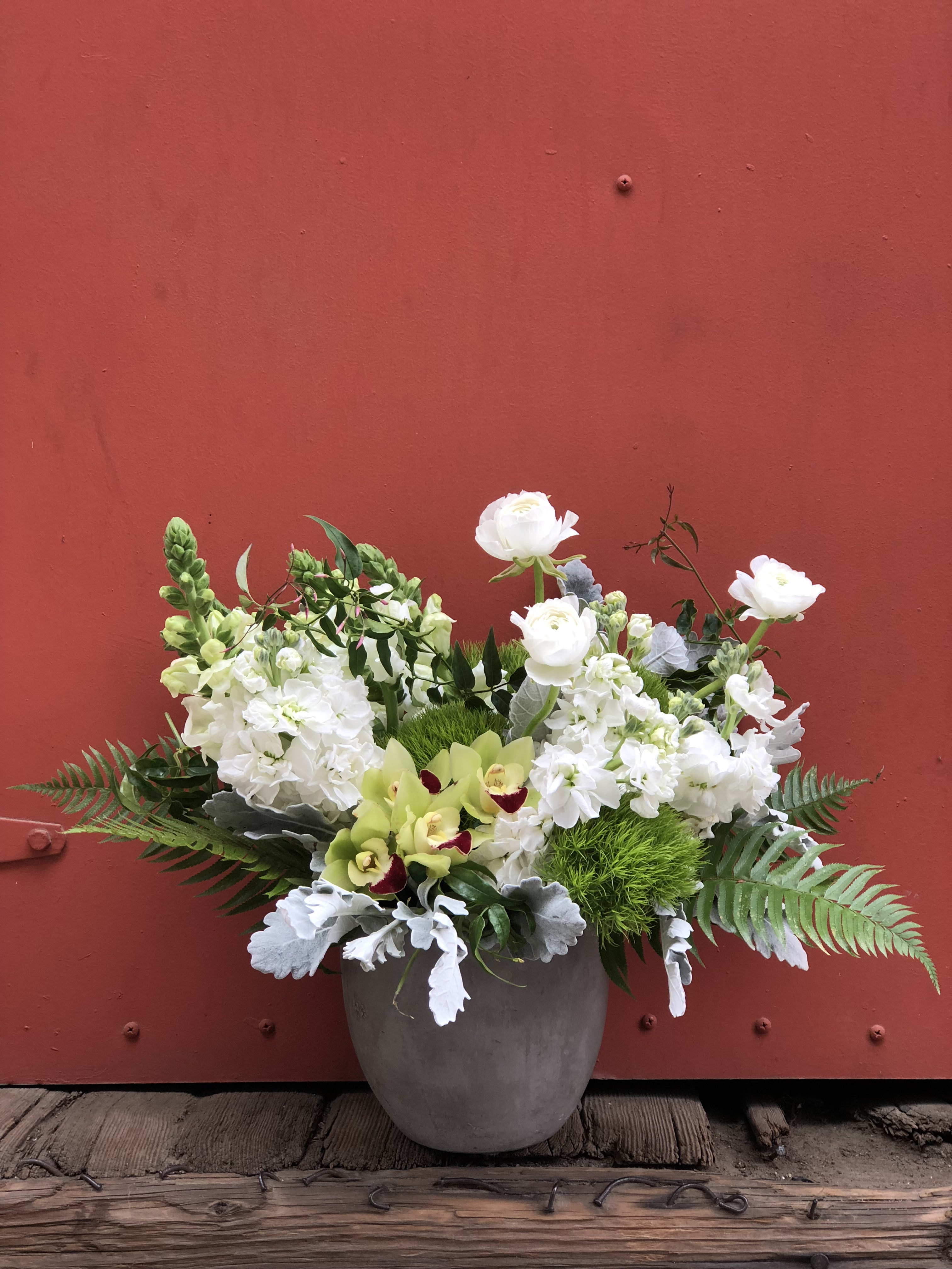 Breath of fresh air - There's nothing like recieving a fresh floral arrangement that makes you pause and enjoy nature's beauty.  This arrangement was made with that very idea in mind.  Take a deep breath, exhale and enjoy this lovely bunch of fragrant stocks, snap dragons, ranunculus, ferns and orchids designed in a concrete style container.  