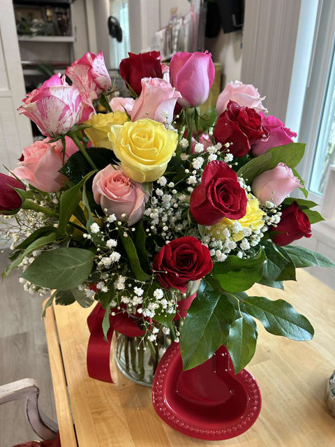 Spectrum of Affection Spectrum of Affection - The roses are in a variety of colors: deep reds for a traditional romantic gesture, soft pinks for sweetness, bold yellows for warmth and friendship, and a few with a mix of pink and white, which add a unique and whimsical touch to the mix.