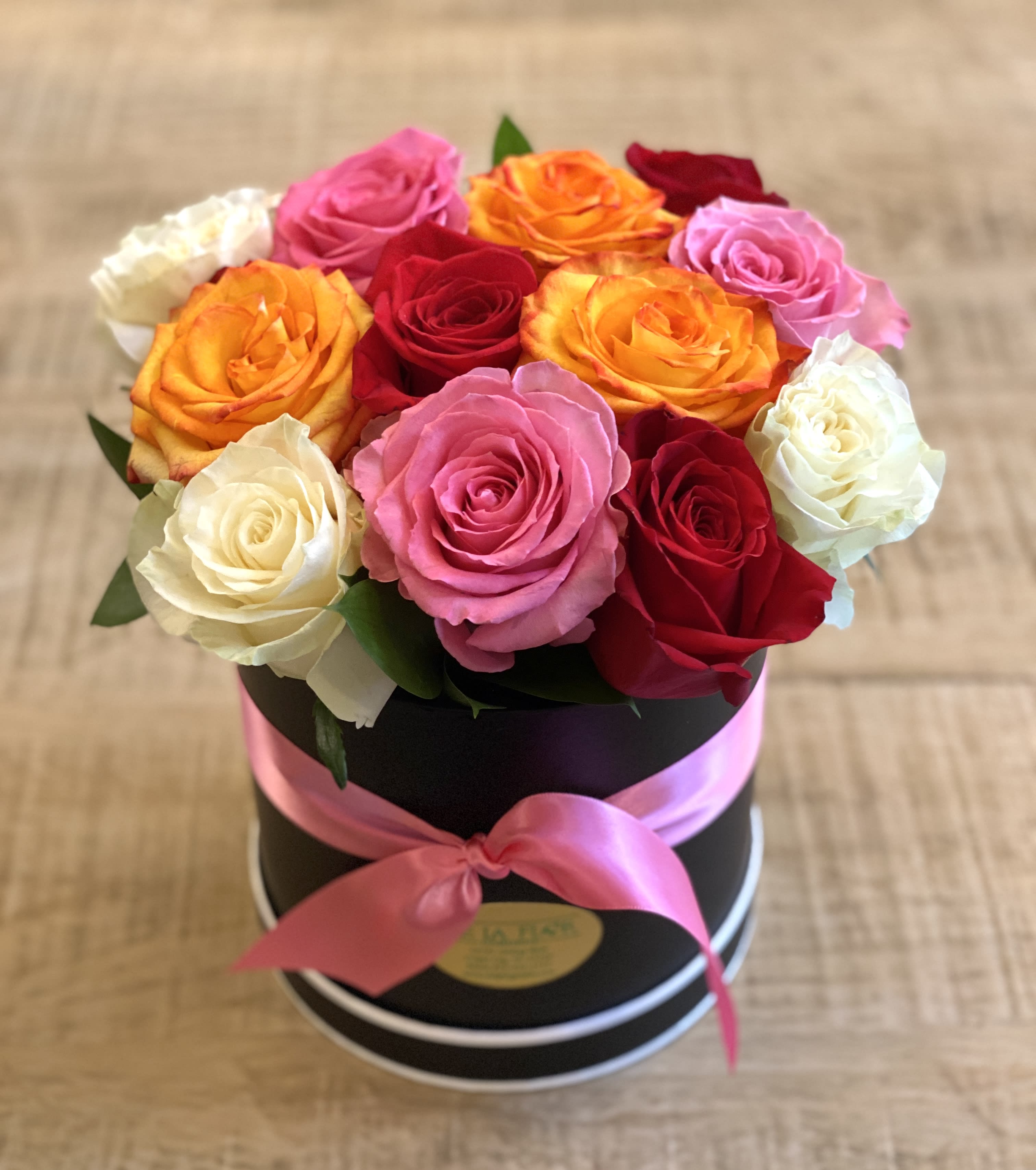 Colored Rose Hatbox - Send a little love with this beautiful arrangement of 12 mixed color roses! Available for pickup or local delivery only!