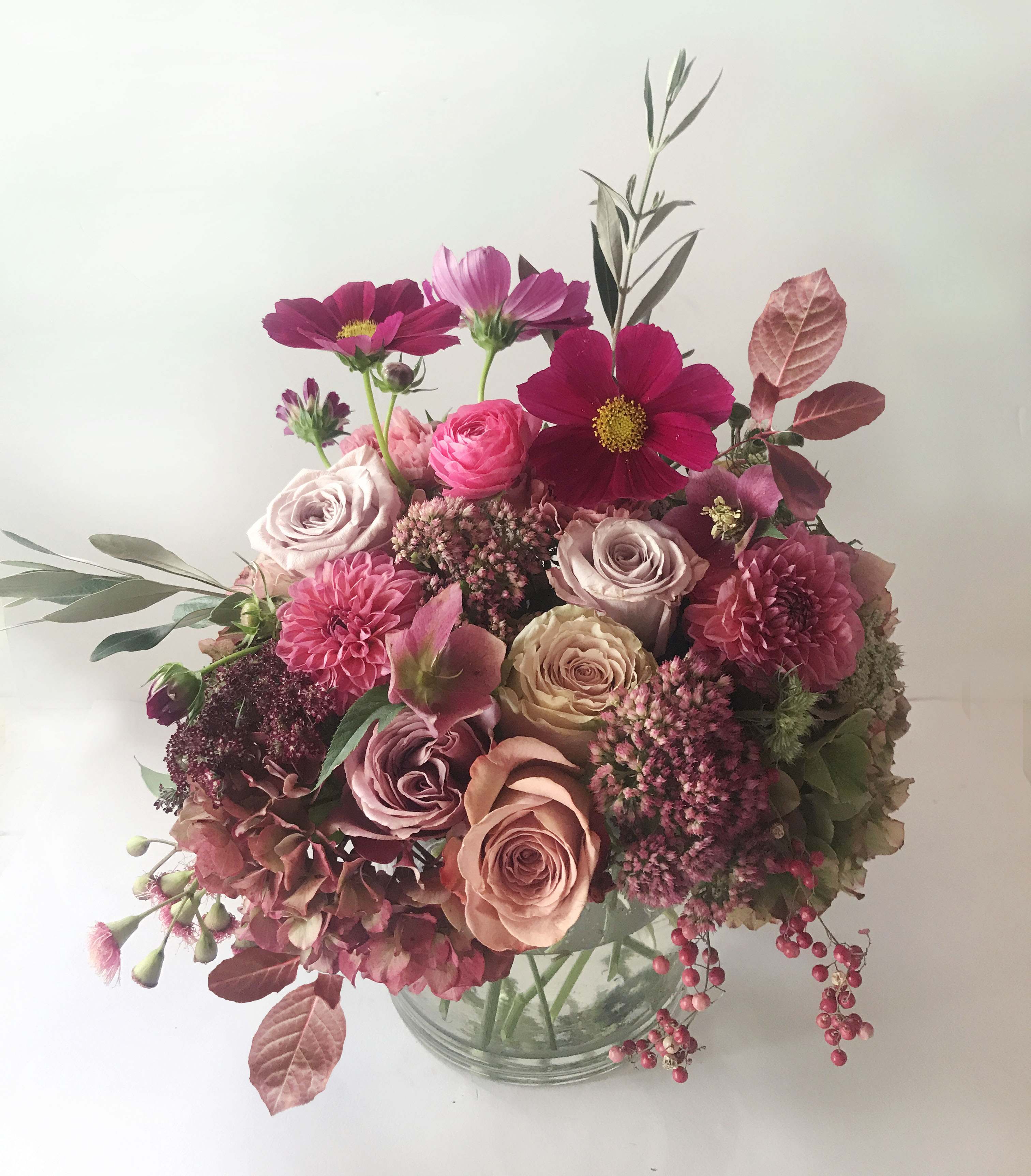 Topanga Topanga - A natural and stylish, rustic arrangement of golden blush, dusty colors, and textures inspired by south of France. A perfect fashionable palette. Let a special someone enjoy the pretty seasonal flowers placed in a clear cylinder vase.