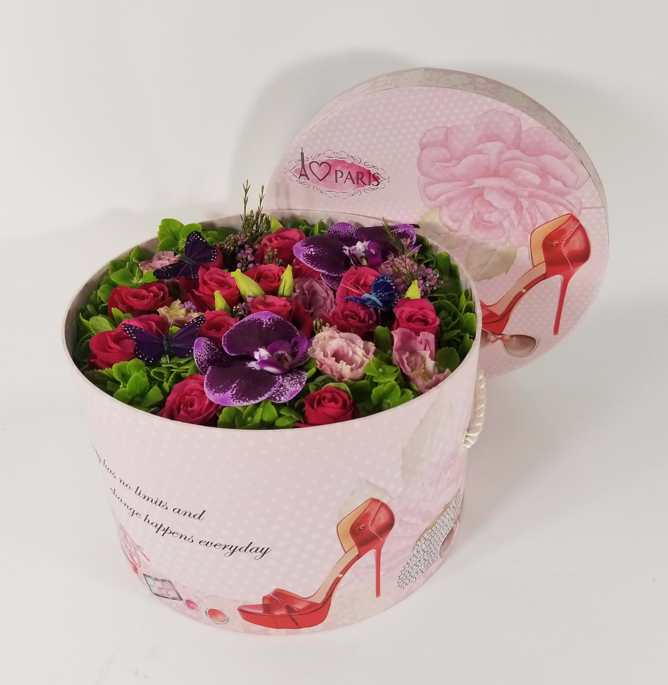 Pandora’s Love Box - Green Hydrangeas, Hot Pink Roses, Pink Lisianthus, Phalaenopsis Orchids, Floral Fillers, and Butterflies.  Approximately  10&quot; H by 18&quot; W Box’s color and design may change due to availability.