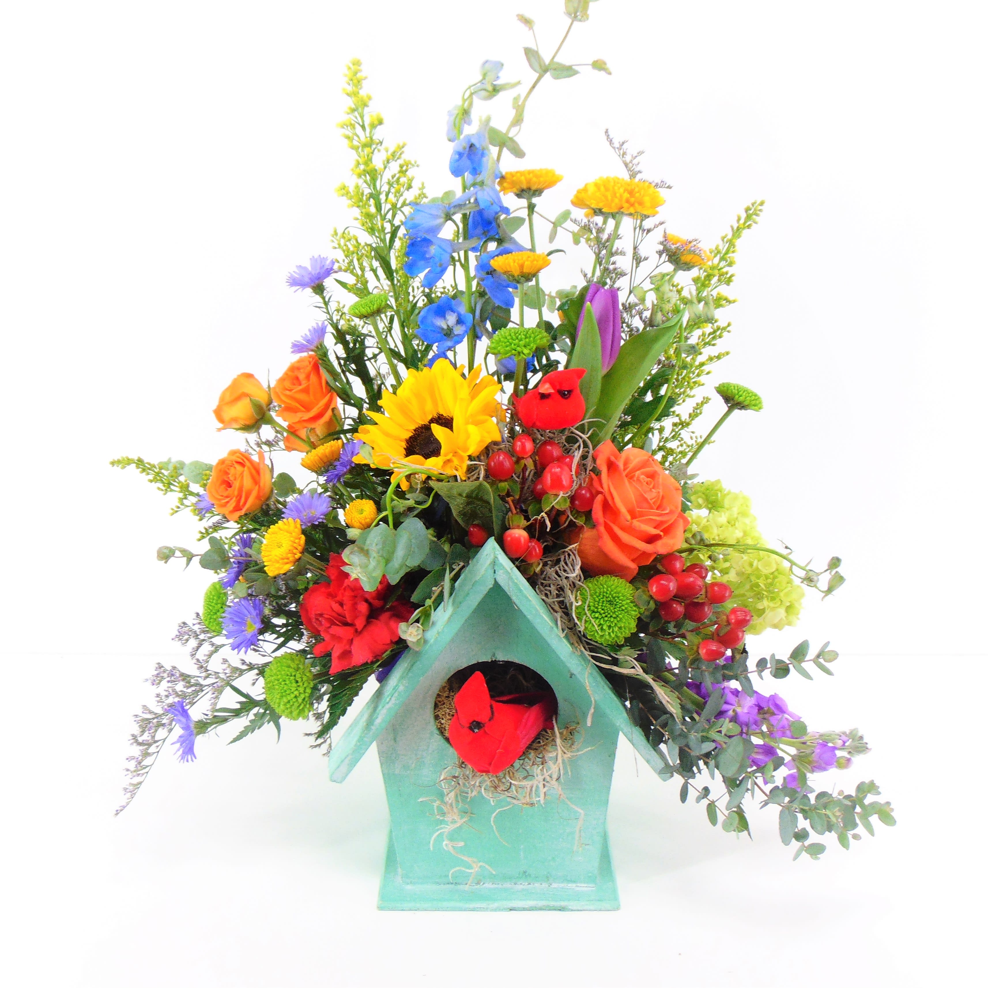 Enchanted Forest - An enchanted bouquet of fresh flowers artfully arranged to express nature's bounty   Deluxe option is pictured. Assorted birdhouse colors of yellow, green or pink.