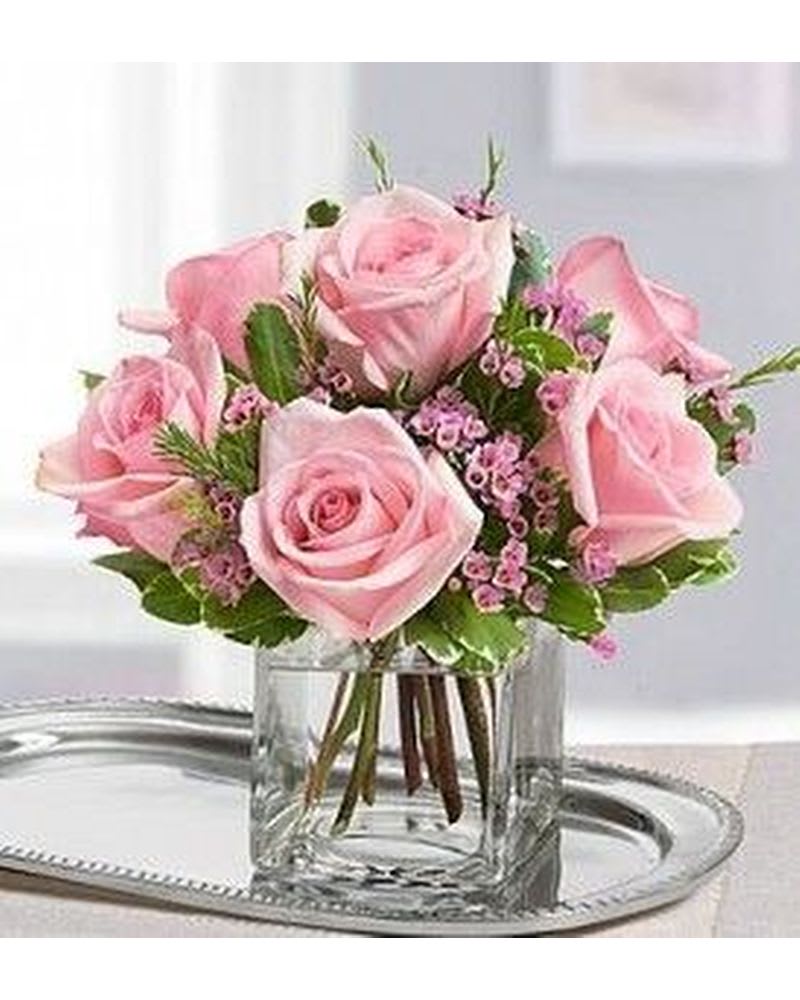 Cherished in Pink  - 6 pink roses in a clear cube vase with variegated Pittosporum and pink wax flower