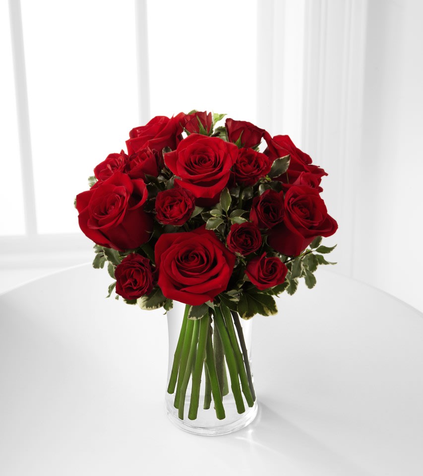 The FTD® Red Romance™ Rose Bouquet - The FTD® Red Romance™ Rose Bouquet will dazzle your special recipient with its expression of love and beauty this coming Valentine's Day. Rich red roses and spray roses are gorgeously arranged in a clear glass vase, accented with a lovely mix of greens, to create a bouquet bursting with romantic intentions.  
