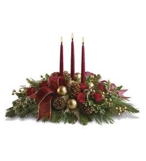 All is Bright All is Bright - A centerpiece of mostly Christmas greens but with little pops of red mini carnations and gold baubles (Roses and spray Roses are added in the larger arrangements) *includes 3 taper candles *** Ribbon, candle color & glass bulb color may vary***