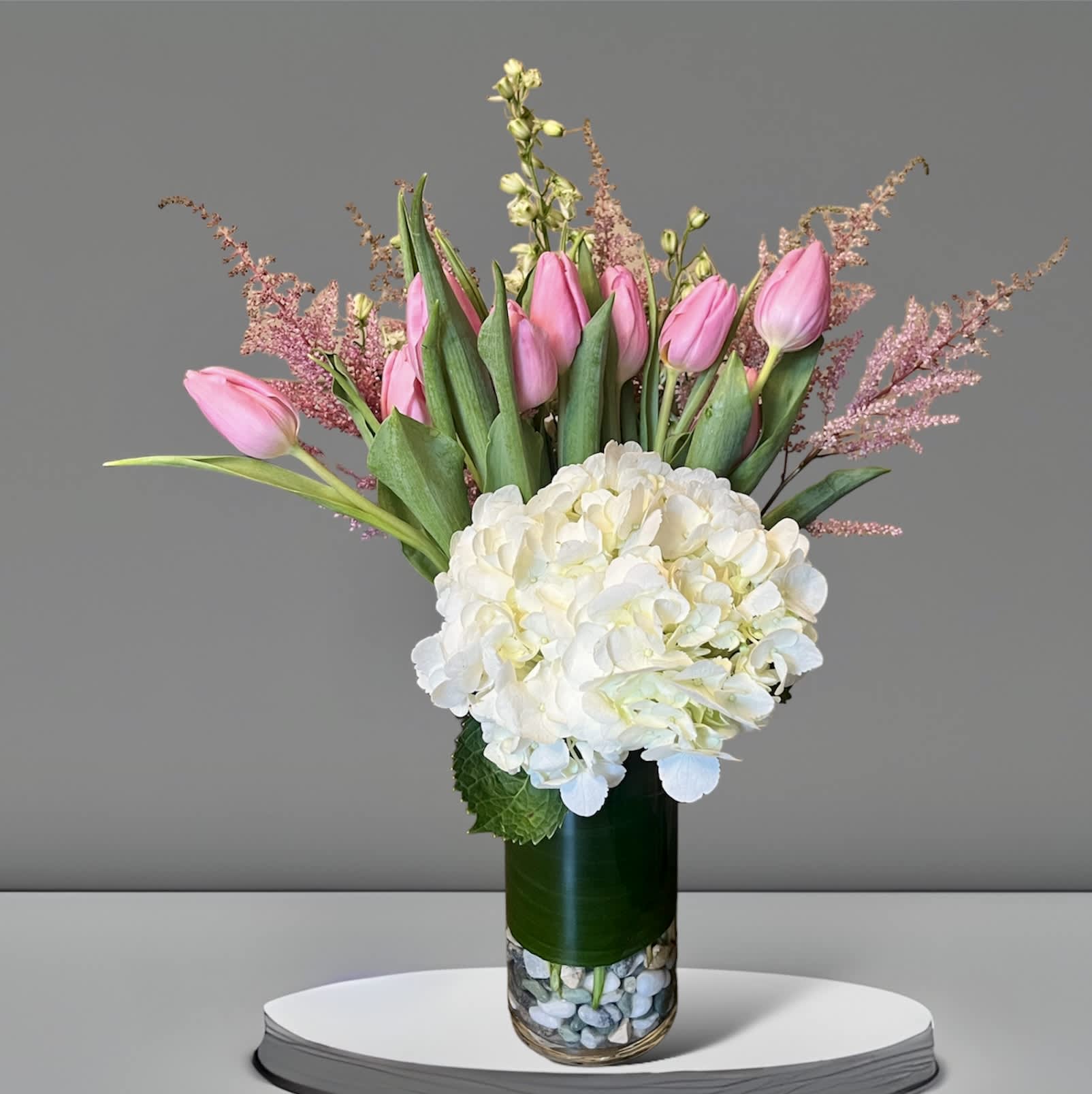 Dear One - Show your appreciation with this sweet, fun bouquet. This arrangement contains white hydrangea, pink tulips, and pink snapdragon. Perfect gift for Mother's Day, Birthday, or Just Because. APPROXIMATE DIMENSIONS: 14&quot; H X 16&quot; W