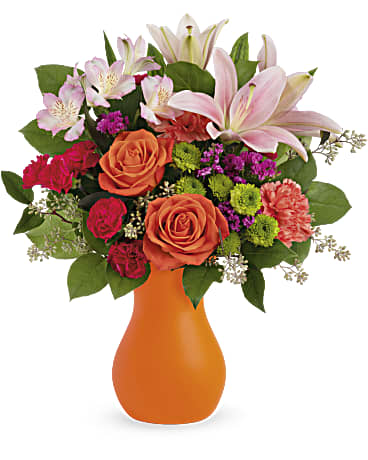 Happy Go Citrus Bouquet - This happy splash of bright orange roses and playful pink lilies arrives in a playful frosted glass vase. The perfect pick-me-up for any occasion! Orange roses, pink asiatic lilies, orange carnations, miniature hot pink carnations, green button spray chrysanthemums, pink alstroemeria and raspberry sinuata statice are arranged with seeded eucalyptus and lemon leaf. Delivered in a Serendipity Glass Vase. Orientation: All-Around