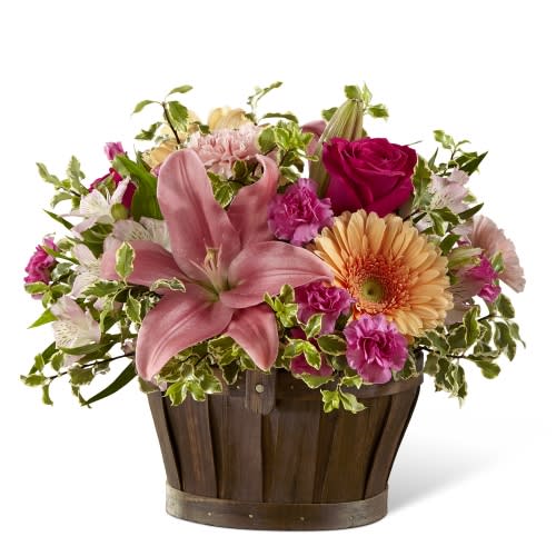 Spring Garden Basket Arrangement - A beautiful arrangement of pink Lilies, pink Carnations, hot pink Roses, peach Gerbera Daisies, lavender mini Carnations, pink Alstroemeria, &amp; lavender Daisies come together with mixed greens to create a gorgeous bouquet for any occasion. **Baskets will vary with availability, we will sub as similar as possible***