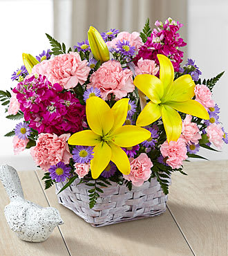 Bright Lights Bouquet Bright Lights Bouquet - A beautiful arrangement of lavender Monte Casino, pink mini Carnations, pink Carnations, fuchsia Stock, and yellow Lily's come together with mixed greens in a white basket. *** BASKETS MAY VARY WITH AVAILABILITY, WE SUB AS SIMILAR AS POSSIBLE****