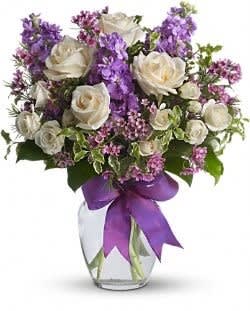 Enchanted Love Bouquet - White roses and fragrant stock in lavender and purple arranged in a vase. This arrangement is an all-time favorite!