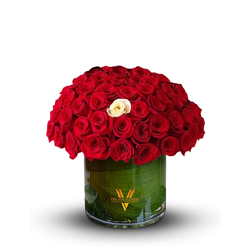 One in a million - A single white rose stands out amidst a sea of vibrant red roses, creating a striking contrast that symbolizes uniqueness and individuality. This one-of-a-kind arrangement makes a compelling statement, perfect for occasions that call for something truly exceptional.