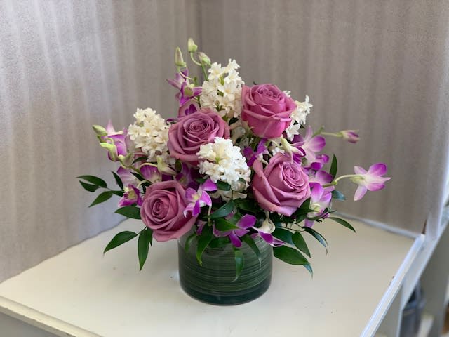 Frangrant Spring - Cube or cylinder of roses and orchids accented with frangrant hyacinths. Everything a floral arrangement should be!