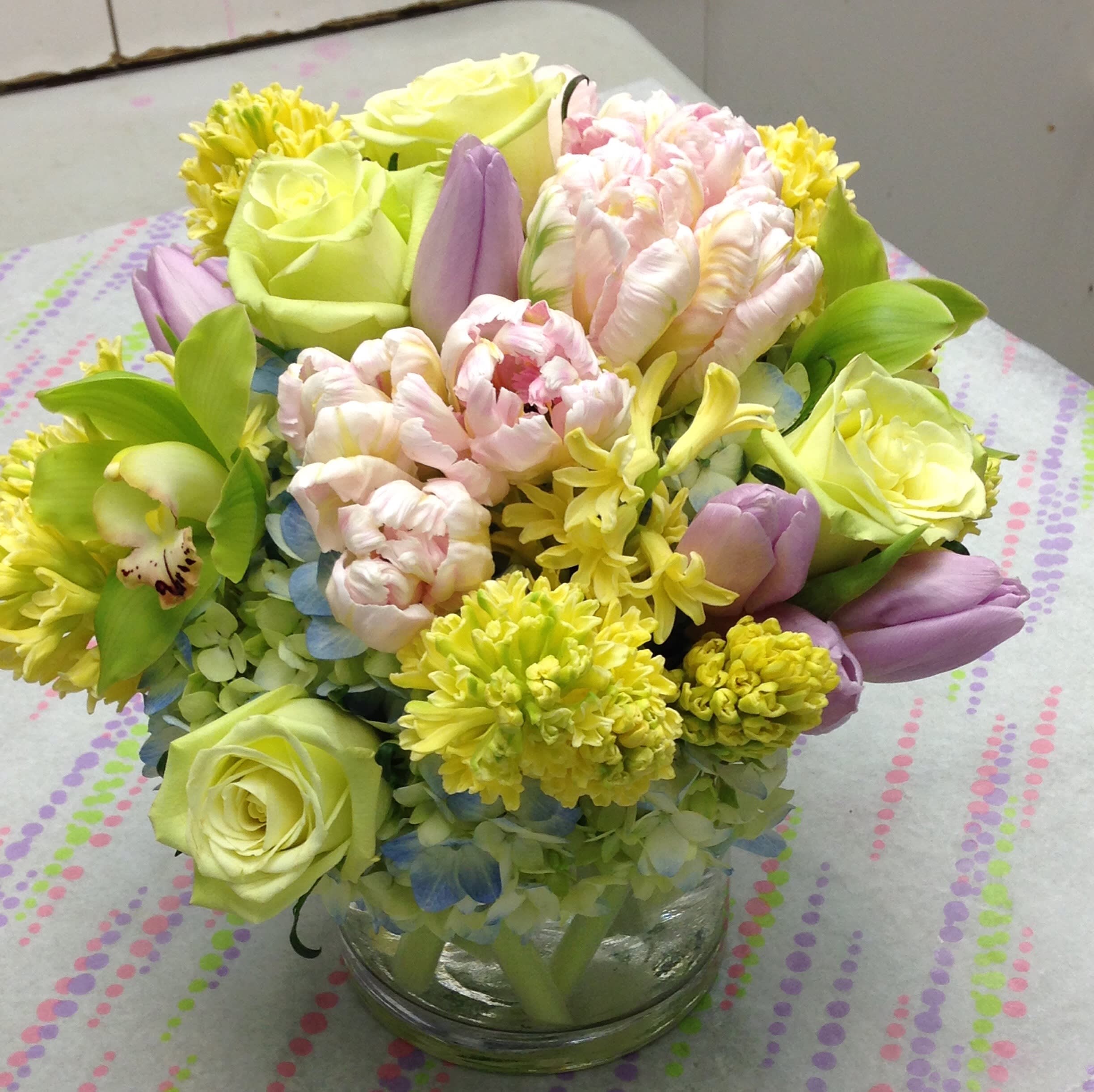 Springtime Pastels - Perfect when the occasion calls for a softer look...birthdays, baby/bridal showers, christenings...Assorted spring blossoms in a cube or cylinder.