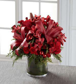 Season's Sparkle Bouquet Season's Sparkle Bouquet - A beautiful arrangement of burgundy mini carnations, red alstromeria, roses and lilies in a cylinder vase. ***Containers may vary***