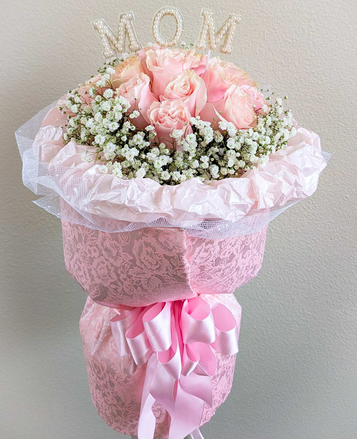 Mom Chanel Style Bouquet  - 1 dz. Pink roses surrounded by baby's breath, arranged in 6&quot; x 6&quot; glass cylinder vase, and wrapped Chanel Style with patterned fabric and accented with MOM lettering.