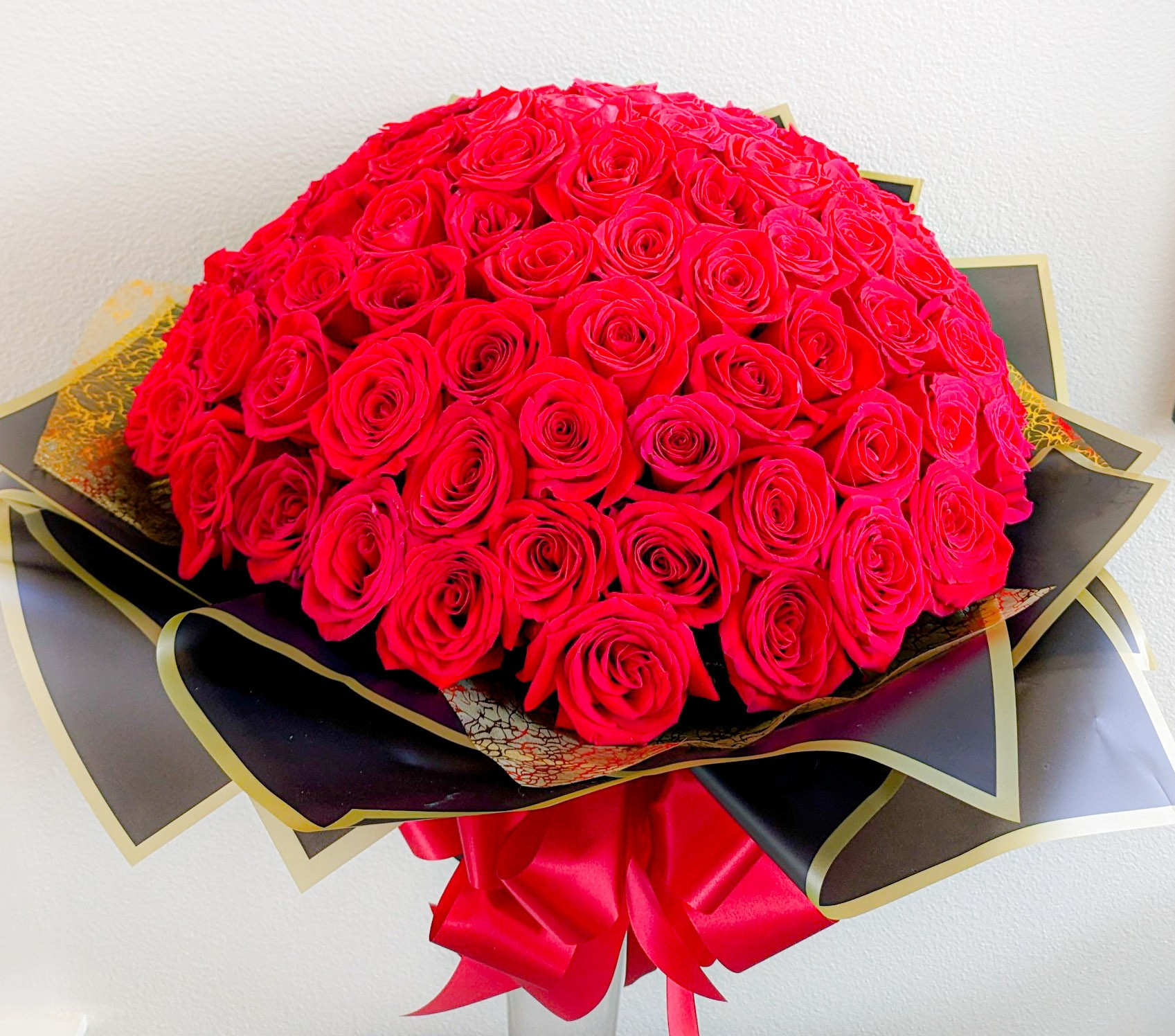 100 Red Roses Bouquet 100 Red Roses Bouquet - 100 Red roses arranged in foam and wrapped with elegant black and gold jelly paper.