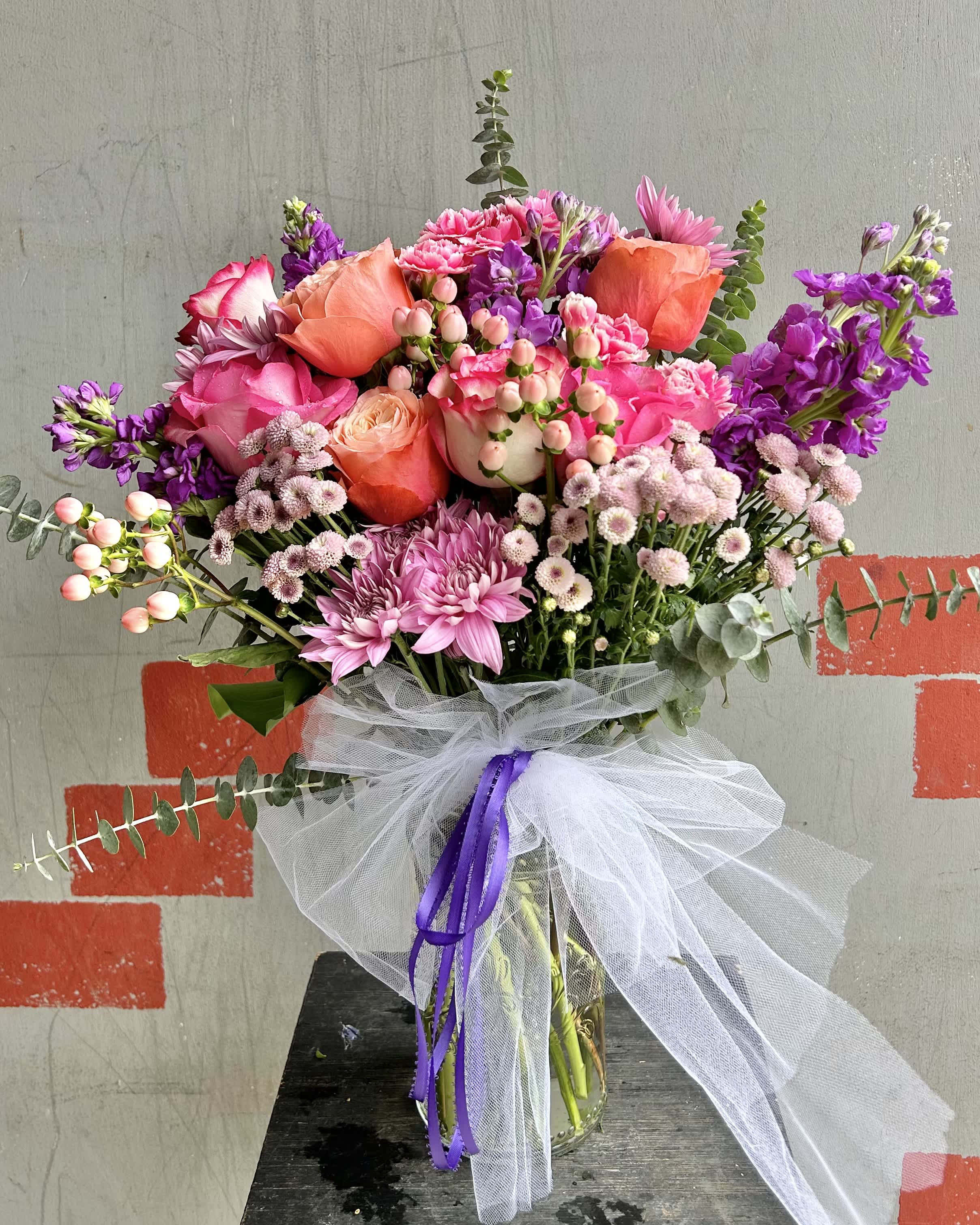 Blushing  - Beautiful pink and purple arrangment with roses, stock, berries, mini chrysanthemums, and green accents.