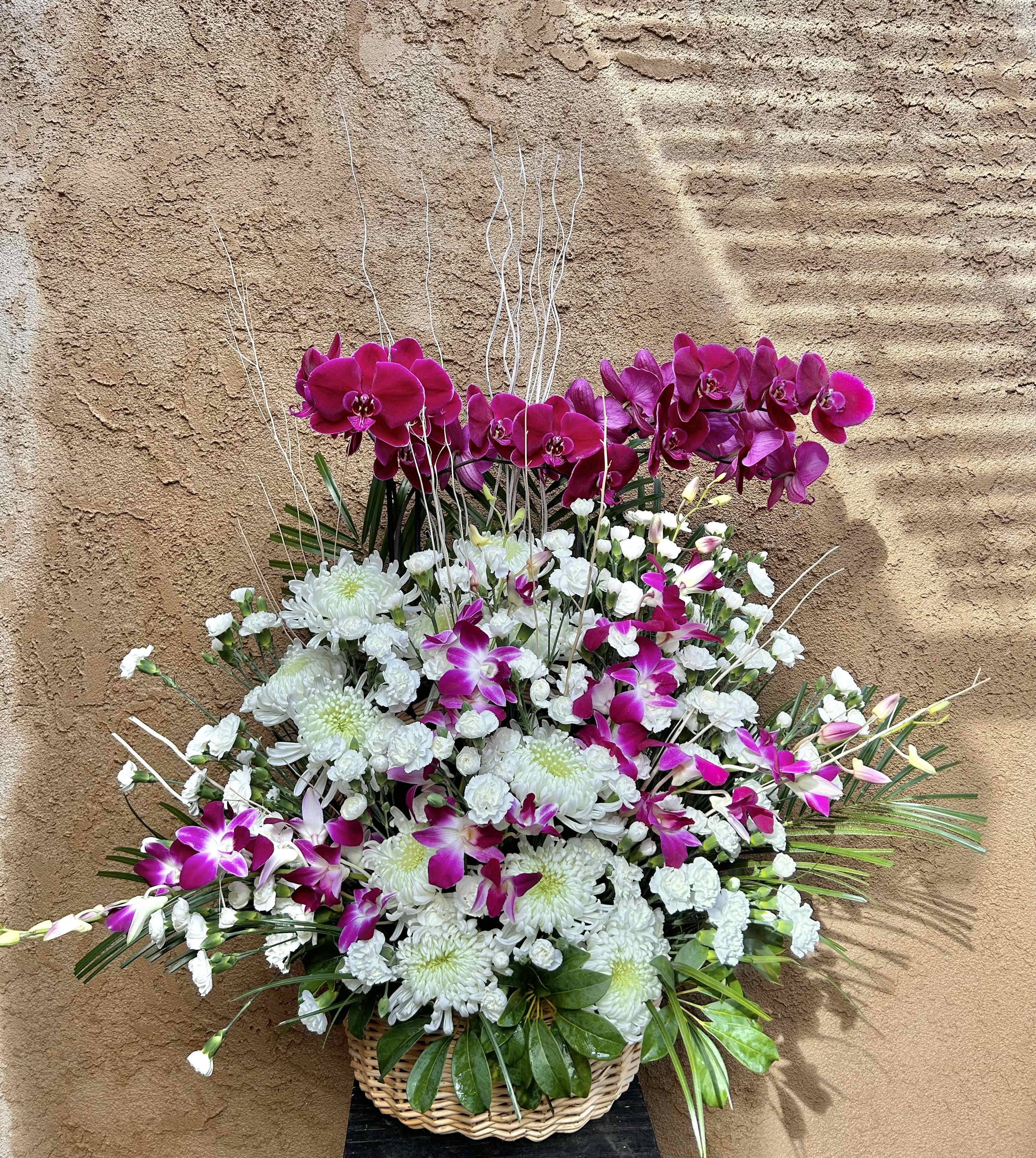 Basket of Purple Orchids - Beautiful basket arrangment of purple orchids and white and green accents.