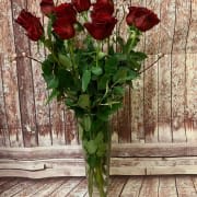 Classic Dozen Red Roses in Vase - A charming bouquet of a dozen (12 stems) of long-stemmed red roses, adorned with decorative branches, is a classic romantic gift. Presented in a glass or ceramic vase, this bouquet is also a romantic standard for any day of the year.  *Each bouquet is unique and design style may vary slightly.