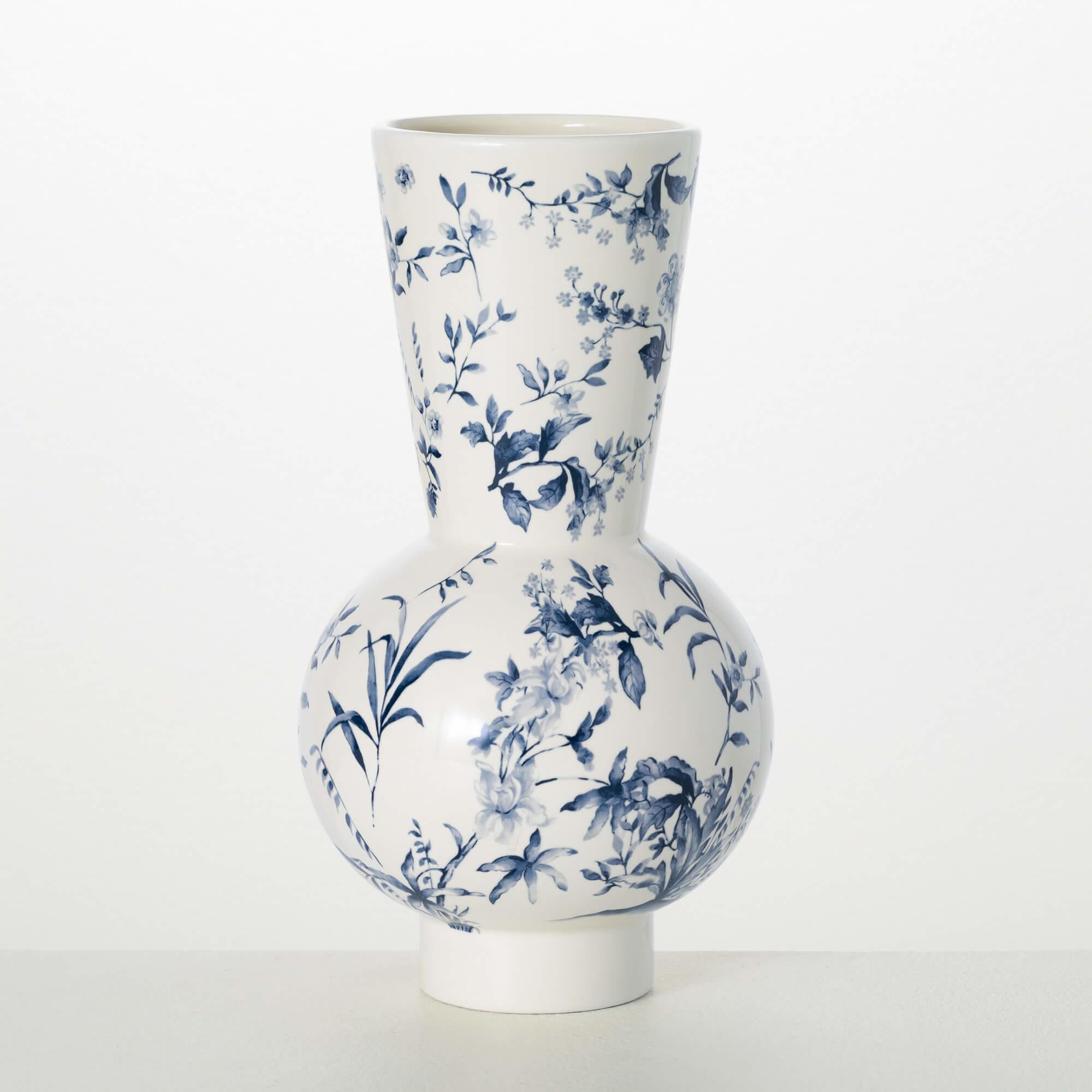Blue Floral modern Vase Blue Floral modern Vase - This vase features blue floral artwork on a stylish, modern shape. Designed in a chinoiserie style, this versatile vase is the perfect accent to a living room, bedroom, or guest bath. Dimensions: 6.5"L x6.5"W x12" Weight: 2.0lbs 4.00oz Material: Ceramic