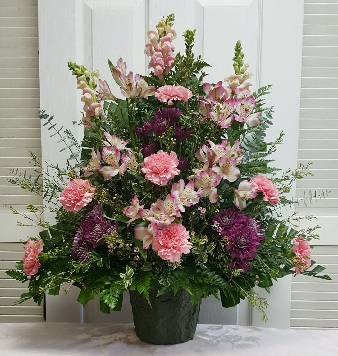 Pink and Purple Majesty Funeral Spray Pink and Purple Majesty Funeral Spray - This Funeral Spray consists of Pink Snapdragons, Carnations and Wax Flower with Purple Cushion Mums and Alstroemeria.