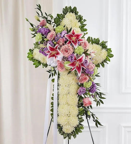 Prayers and Blessings - Standing cross arrangement of white football mums, pink roses, stargazer lilies and lisianthus. Lavender lisianthus and stock with lime green carnations; accented with greenery.