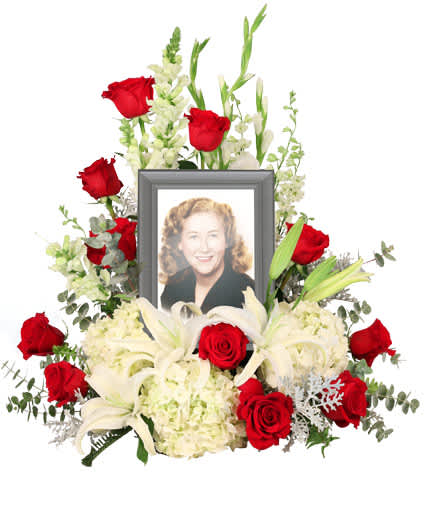 MISSING YOU MEMORIAL  - Honor and celebrate the fruitful life of a lost loved one with an arrangement that truly encompasses their elegance. The Missing You memorial arrangement is a luxurious addition to any memorial service. Encompassing a 5 x 7 picture of your choice, this arrangement features majestic white hydrangeas that will ease the minds and comfort the souls that are grieving with contrasting red roses to represent the vibrance of their life. Picture Frame Not Included 