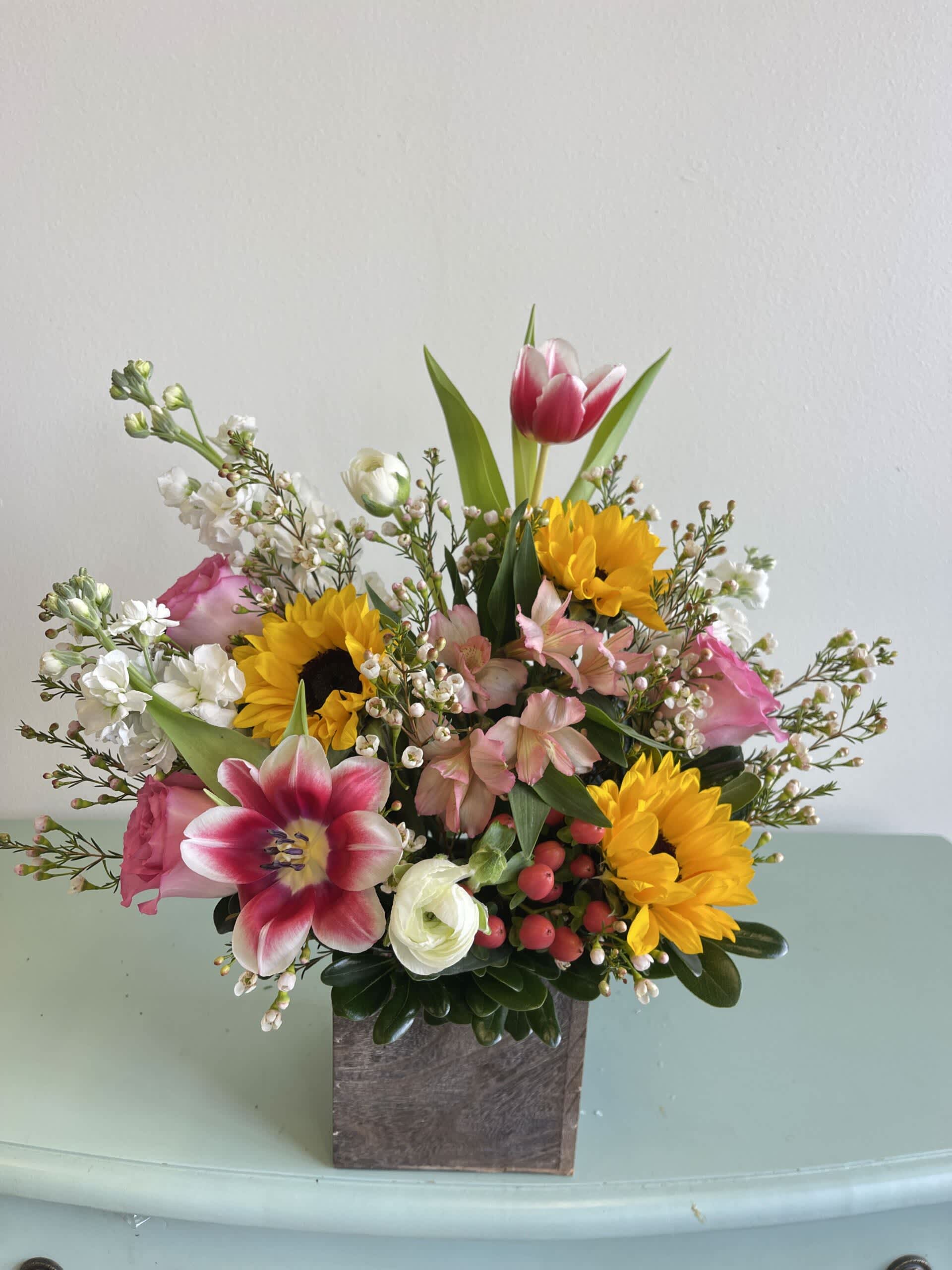 Garden of Love - *ONLY AVAIALBE FEBURARY 12-14TH AND WHILE SUPPLIES LAST*  For the wildflower lover in your life! An arrangement of ranunculus, tulips, sunflowers, roses and other complimentary flowers.