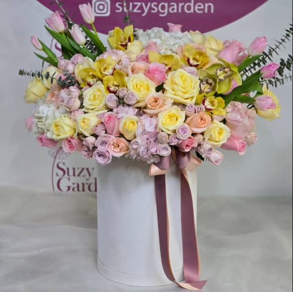 Tulip and Rose Box Arrangement Tulip and Rose Box Arrangement - Preferably pastel range of colored roses, tulips, orchids, and mini roses arranged in a box