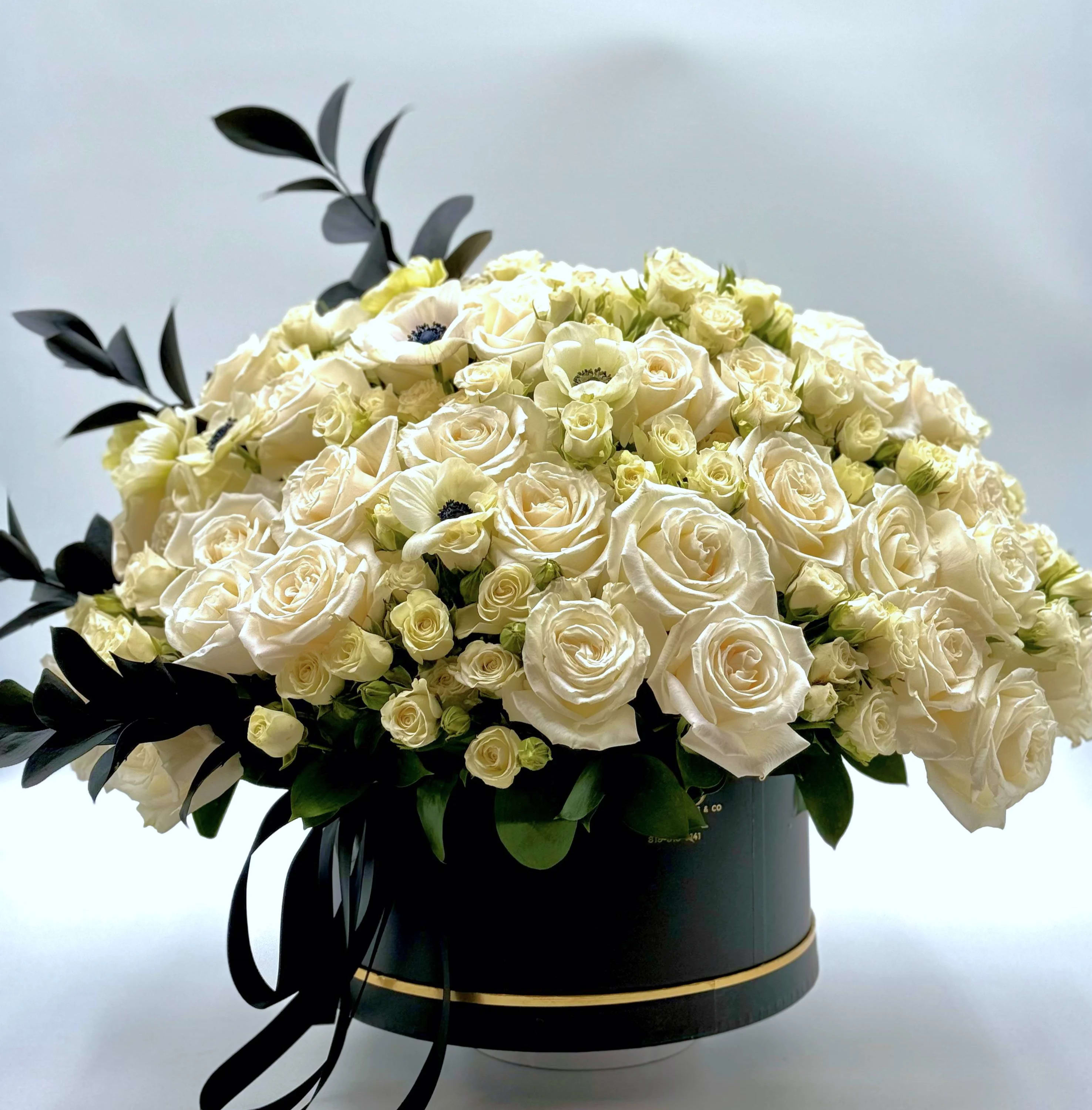 Roses &amp; Anemones! - Whether it is for a happy event or a sympathy gift, you can never go wrong with a classy combination of white and black flowers in a box with a gold accent.