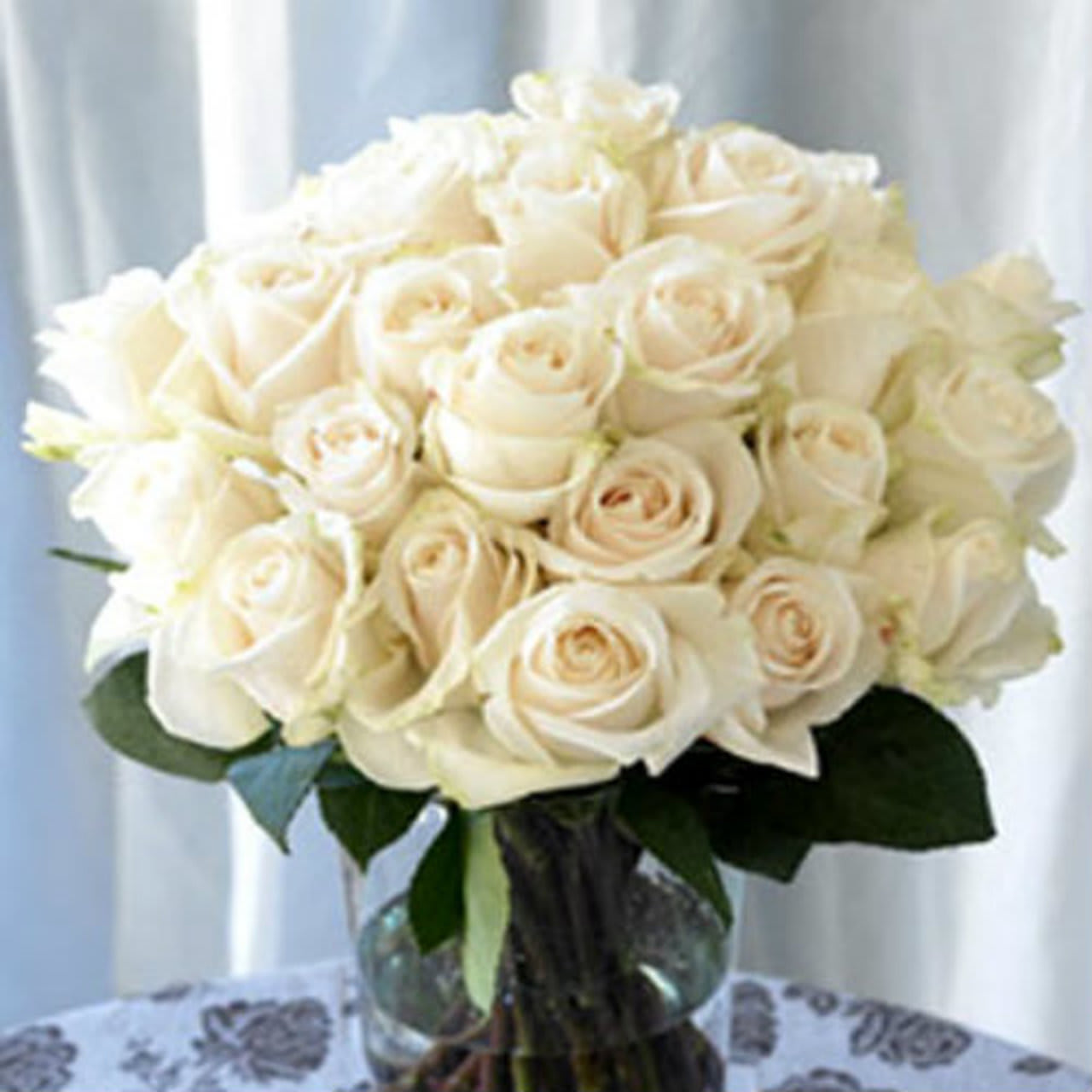White 24 Roses arranged in a vase - 24 White Roses arranged Round in a vase. (Standard) (Deluxe): 30 White Roses. (Premium): 36 White Roses.
