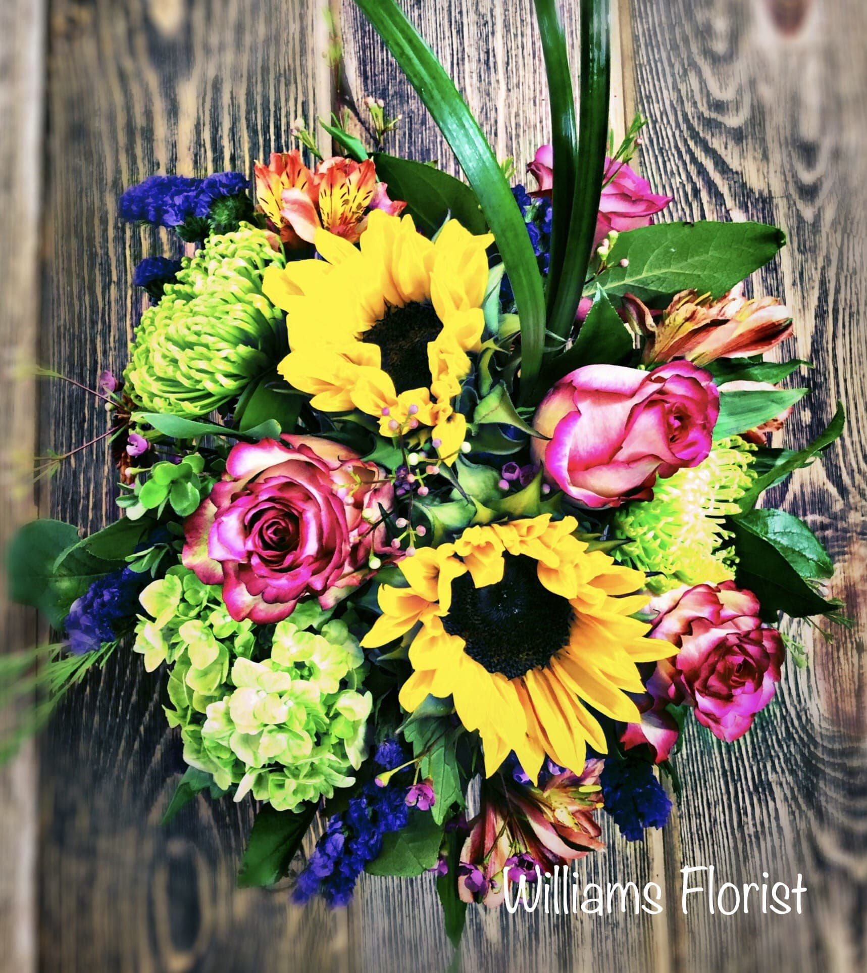 Summer Parade - Designed to be as unforgettable as the person who receives it, our luxurious arrangement of colorful, fresh-from-the-garden blooms, artistically designed inside a chic cube vase by our expert florists, creates the ultimate wow gift for someone who means the world to you.