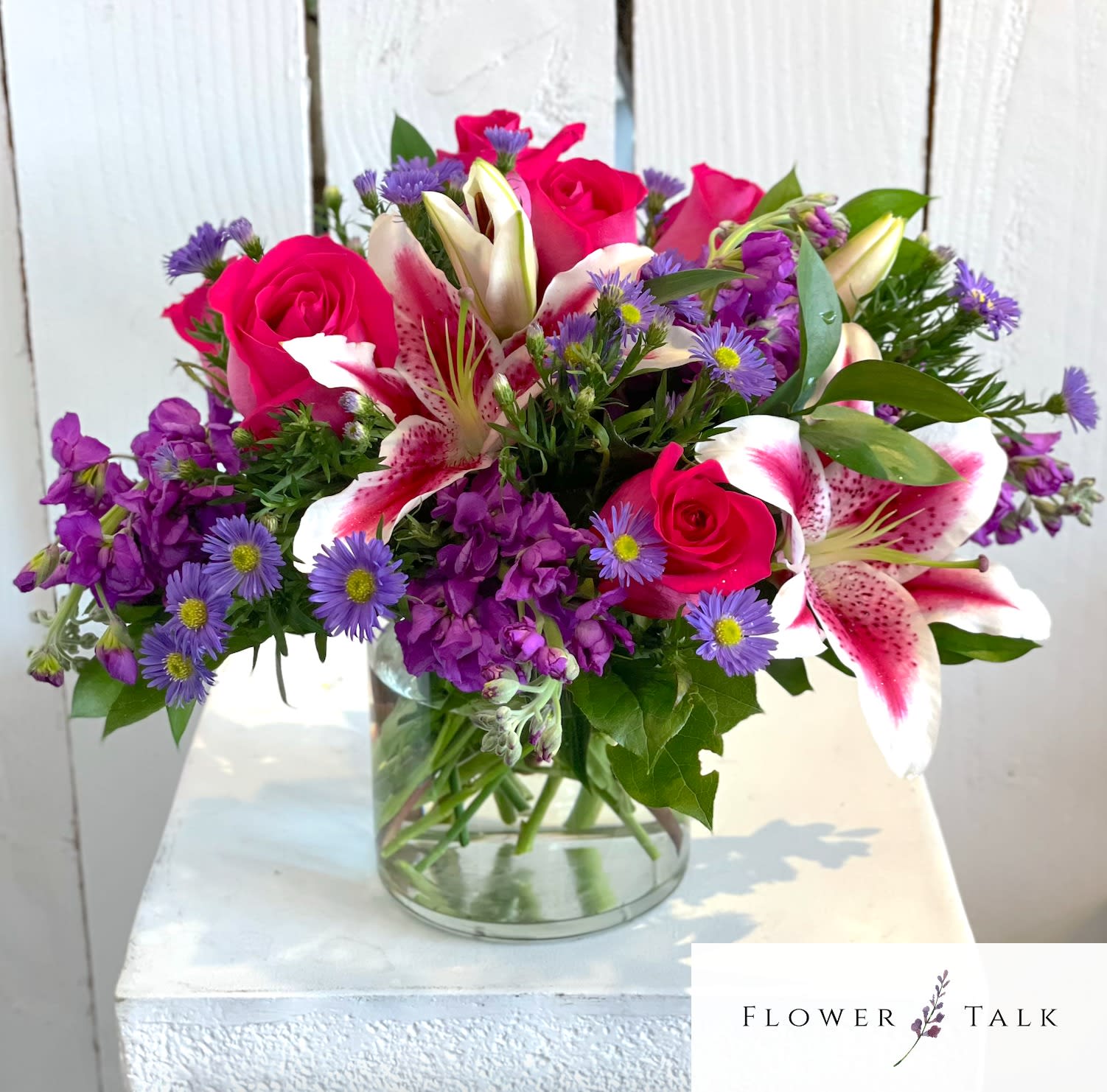Stargaze Beauty - Stunning stargazer lilies with pink and purple blooms in a cylinder vase. 