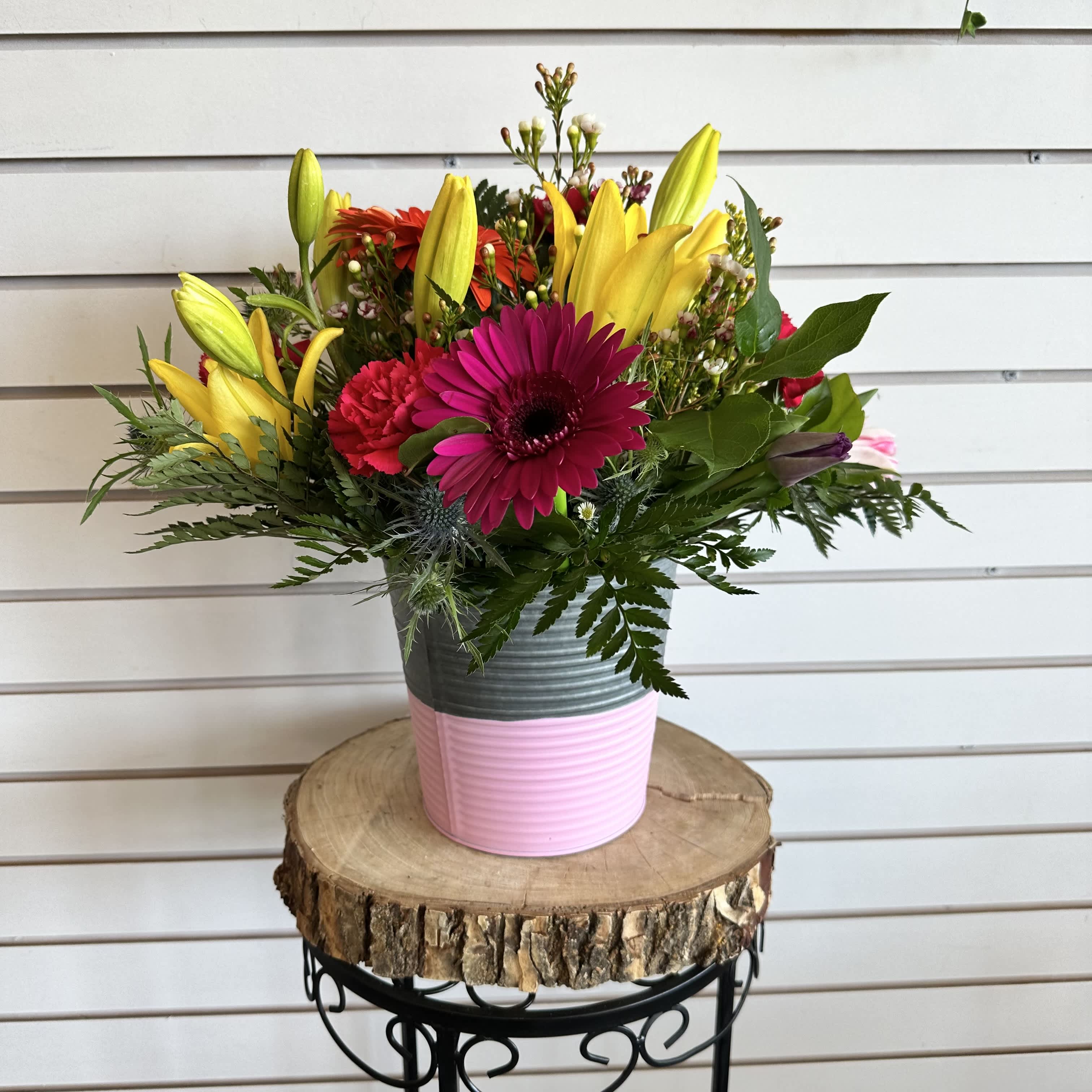 Spring Time Bucket of Blooms - A spring metal bucket with a mixture of bright flowers.   **Colors and flowers may vary depending on shop availability**