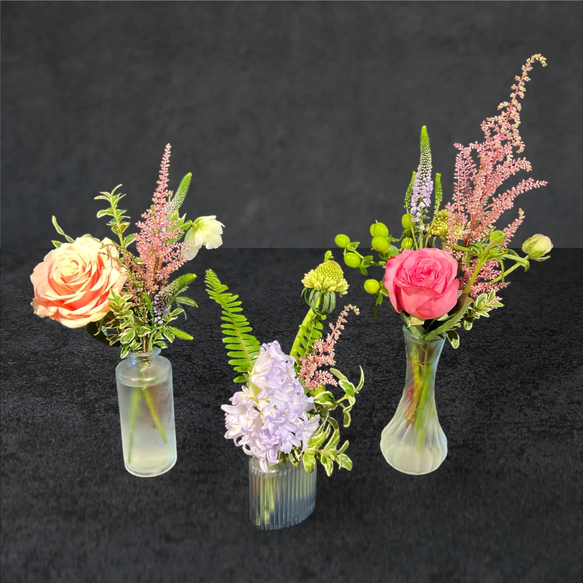 Vintage Bud Vase Trio - This trio of vases.. with tiny flower treasures are a fun and unique floral gift.  All vases and flora vary with each order because we gather these diminutive vessels from and array of places. Color, size, patterns.. filled with a variety of flowers.  Sit one by the sink, on bedside...etc...  Three lil flower happies for your loved one. 