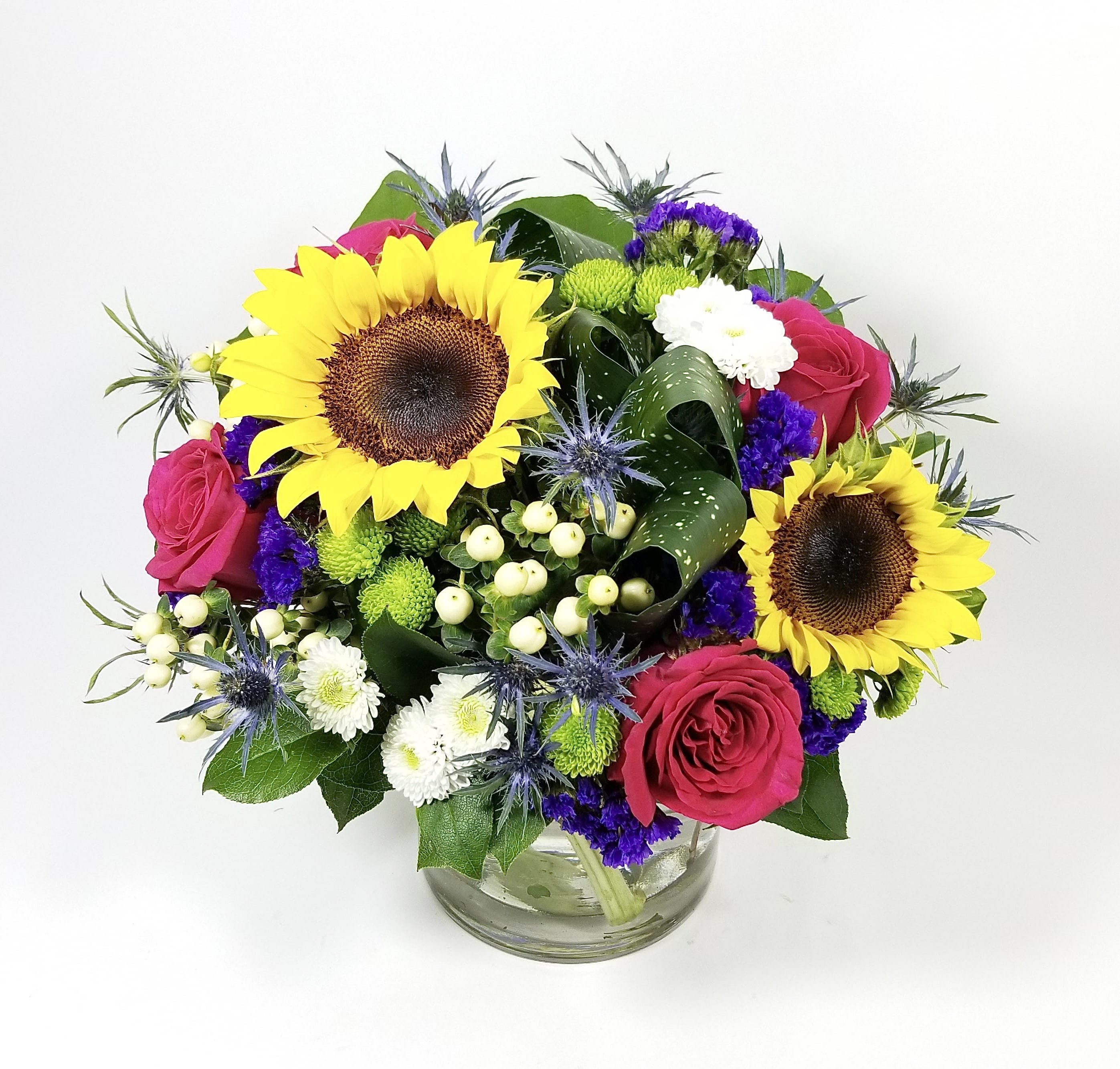 Smile - Bright colorful floral arrangement to brighten up a lucky one's day. Created with the best quality flowers, and greens to make some one smile. 